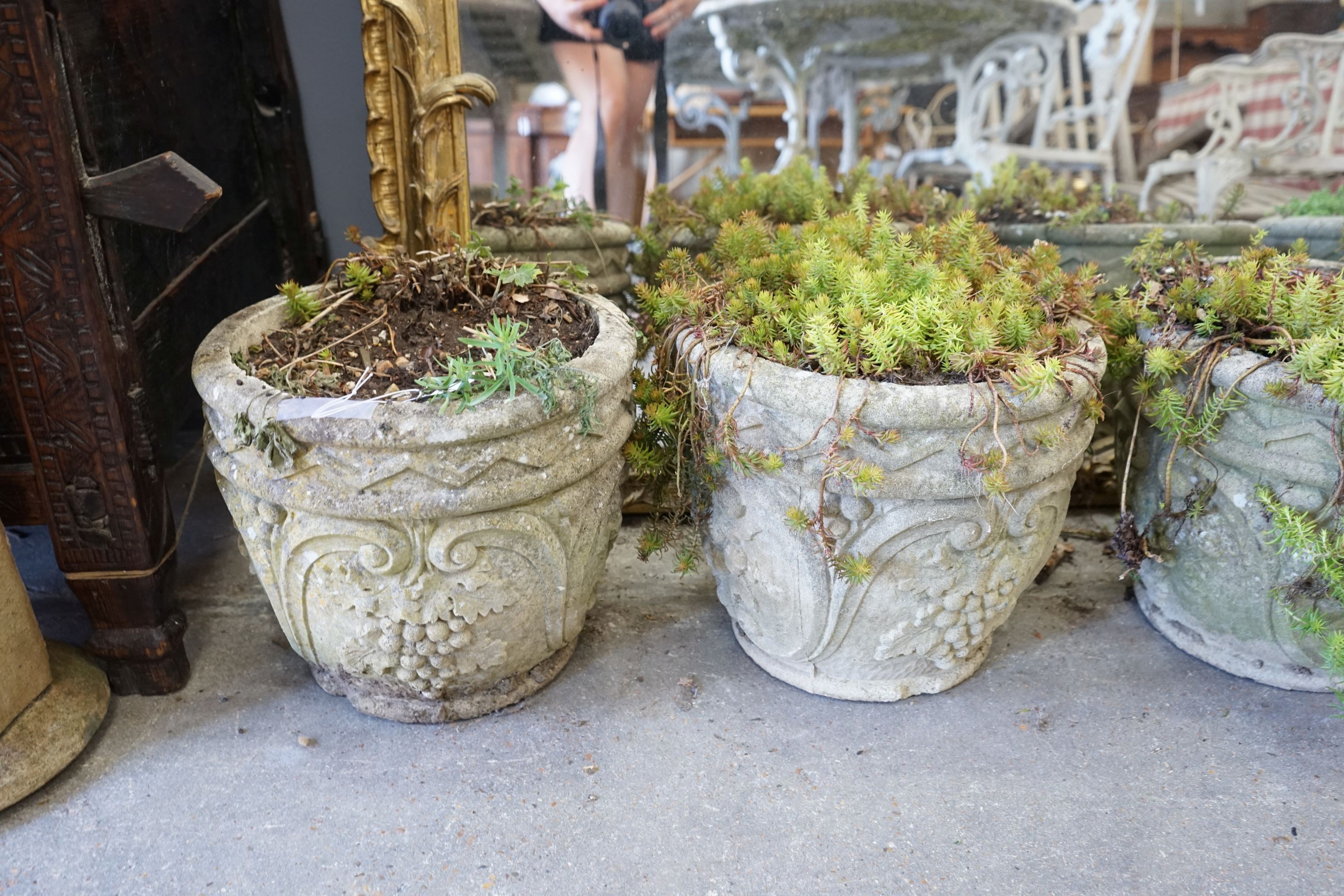 A set of four circular reconstituted stone garden planters, diameter 32cm, height 28cm